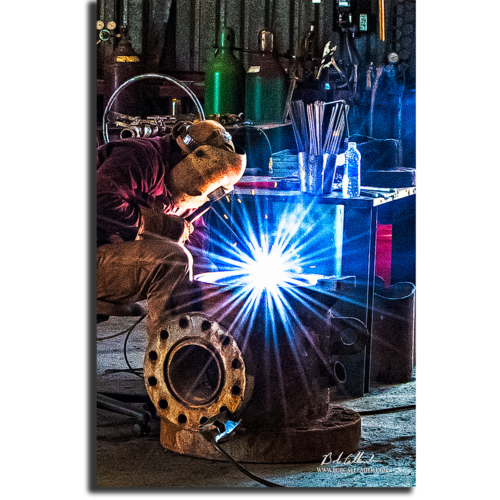 A welder photograph as he is working on the small details of a big project. The Big Idea by Bob Callender