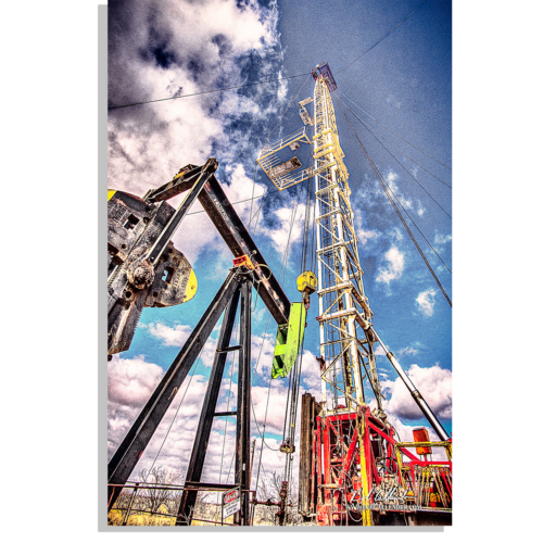 A perfect shot of a pulling unit and pump jack side by side. Workin Liberty by Bob Callender
