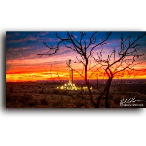 As the sunsets on a mesquite tree and rig the lights come on. Light in the Desert by Bob Callender