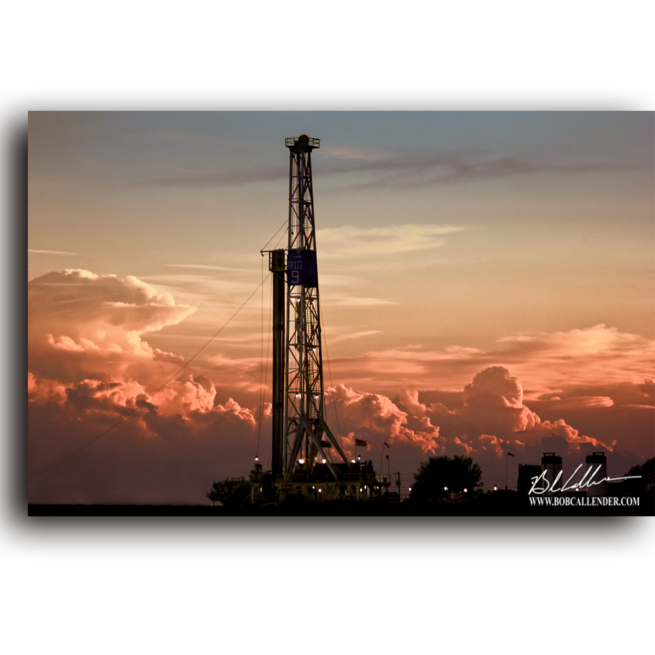 An oil derrick surrounded by clouds at sunset. Dare to Dream by Bob Callender