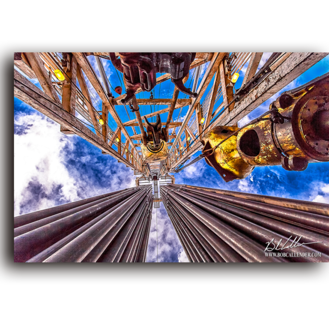 The blue sky and rig top against white clouds. Sky Cross by Bob Callender