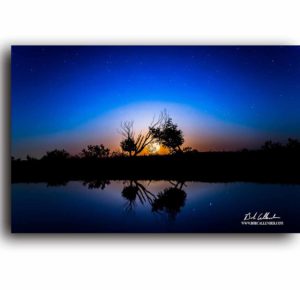 Sunset on a with blues and orange in Sweet Texas Night by Bob Callender.